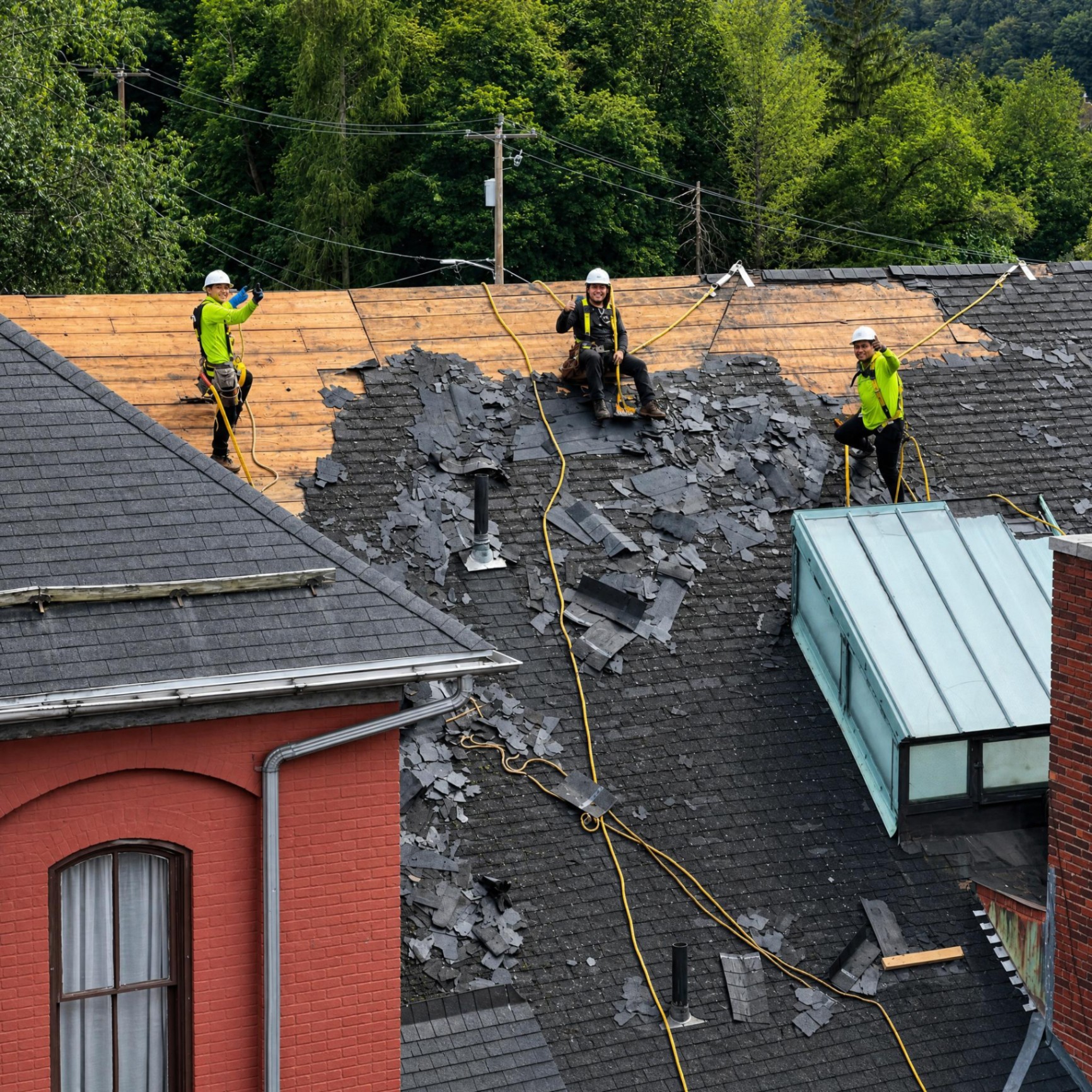 Luis Construction professional crew with harnesses and safety gear on a roof